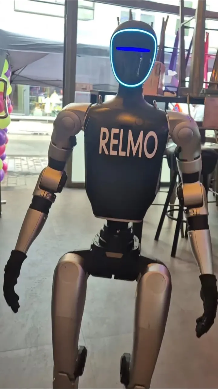 RELMO welcoming visitors at a shop entrance